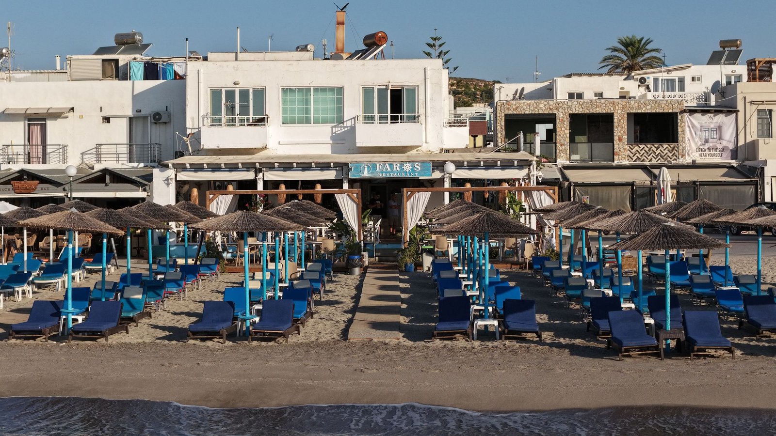 Faros Restaurant and its sunbeds on the main beach at Kardamena